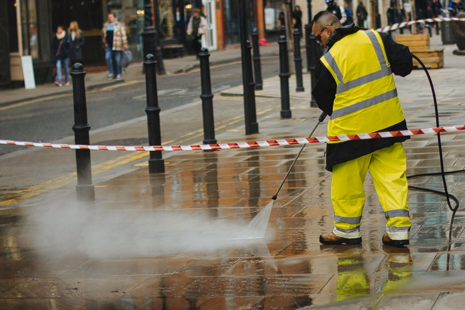 Cleaner using a pressure washer on an exterior surface
